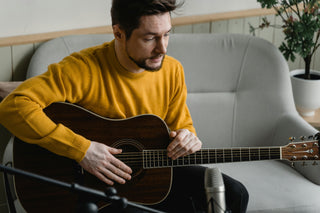 man holding an acoustic guitar